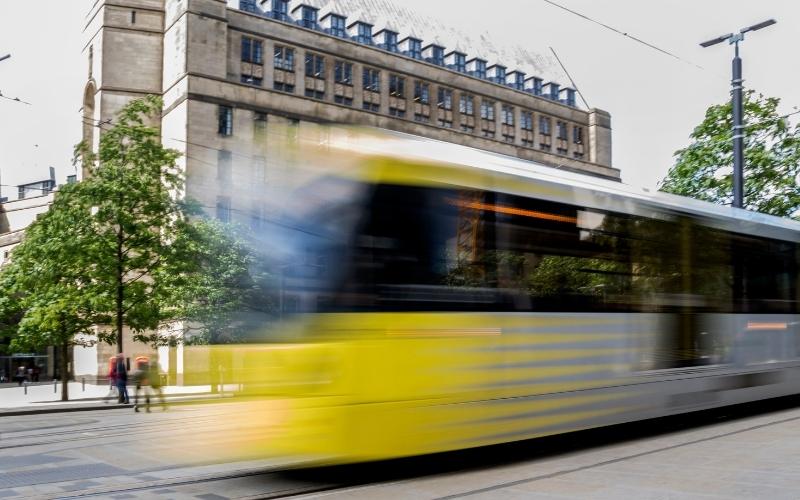 A tram rushes through a busy city - a metaphor for LinkedIn Ads success