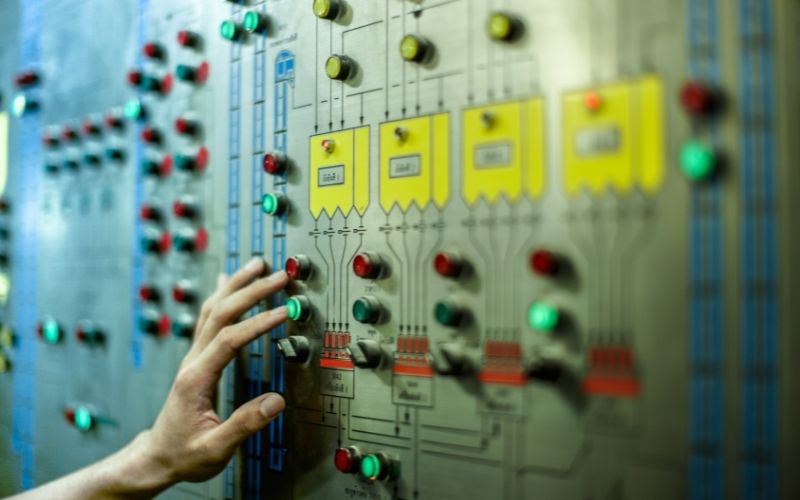 A hand uses a control panel: a metaphor for digital analytics